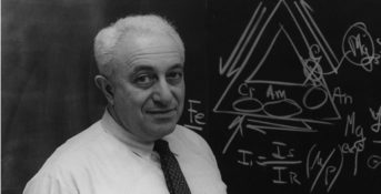Dr. Irving Selikoff standing in front of a blackboard