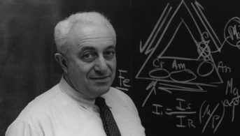Dr. Irving Selikoff standing in front of a blackboard