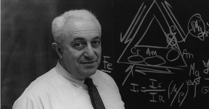 Dr. Irving Selikoff standing in front of a blackboard