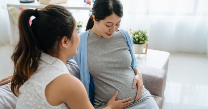 pregnant woman in doctor's office holding belly