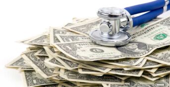 Money below a stethoscope