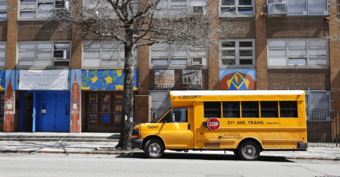 school bus parked in front of a city building