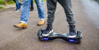 London, England - December 28, 2015: Person Riding a HoverBoard on a Public Footpath, They are now banned in all public places in the United Kingdom. (Lenscap Photography / Shutterstock.com)