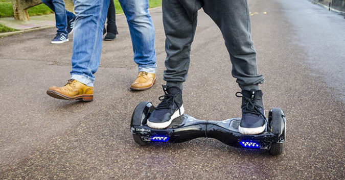 London, England - December 28, 2015: Person Riding a HoverBoard on a Public Footpath, They are now banned in all public places in the United Kingdom. (Lenscap Photography / Shutterstock.com)