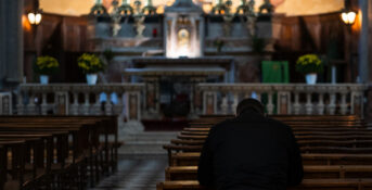 A man kneeling in a church