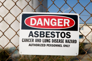 Asbestos sign in front of old building