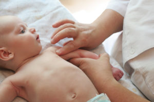 A baby gets an exam by a doctor