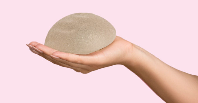 hand holding a breast implant