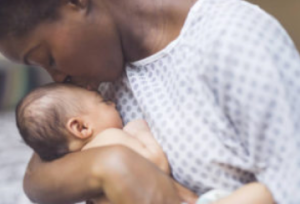 Mother kissing baby with birth injury