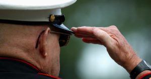 A veteran in uniform salutes