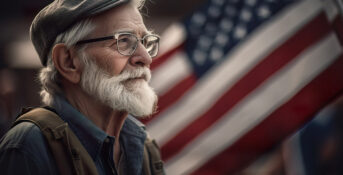 veteran sits in front of American flag