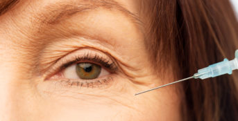 close up of womans eye with syringe