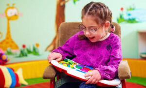 A young child with cerebral palsy plays with a toy