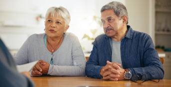 A couple speaks with an attorney