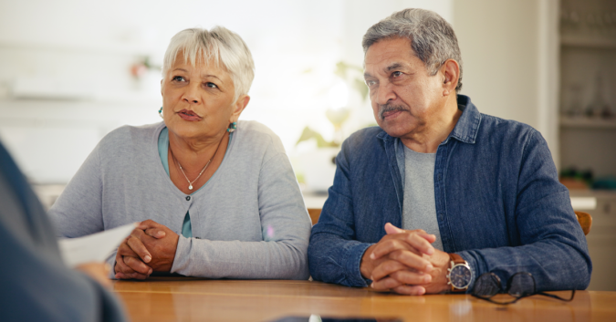 A couple speaks with an attorney