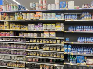 Cow's milk based formula and baby food on a grocery store shelf