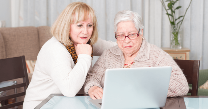 two elderly women looking at a laptop computer