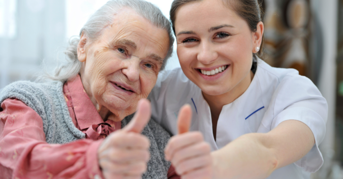 elderly woman with nursing home worker