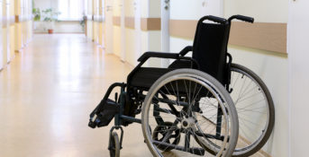 Wheelchair left in an empty nursing home hallway