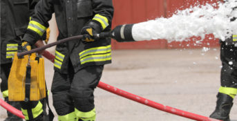 firefighter using a fire hose