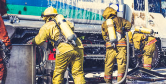 firefighters spraying firefoam