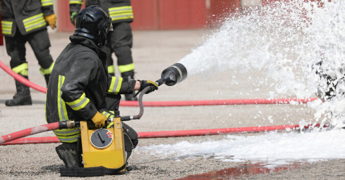 A firefighter using PFAS-containing foam