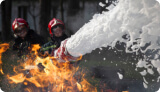 Firefighters using firefoam on a fire