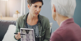 A woman is shown images from a brain scan for meningiomas