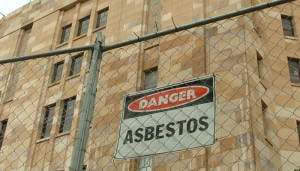 Danger asbestos sign outside old building