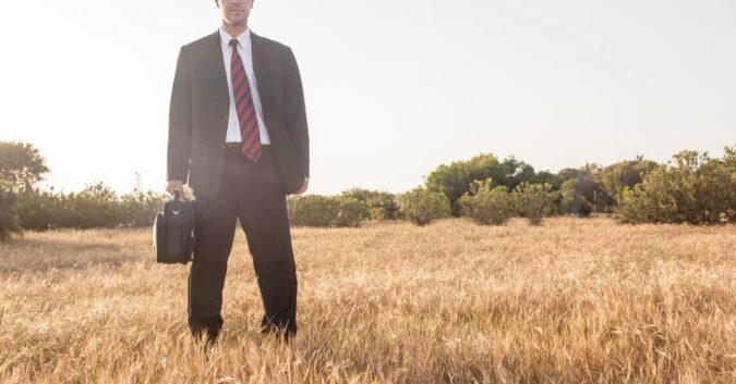 A lawyer stands in a field