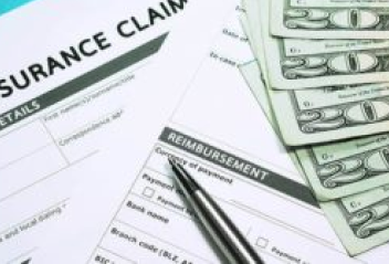 Documents titled "Insurance Claim" with cash on the side of them