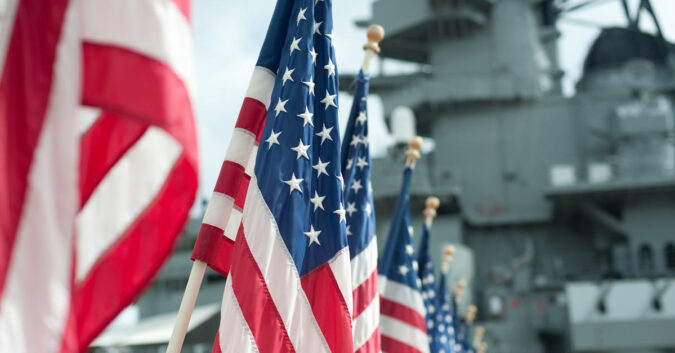 Americans flags before a U.S. Navy ship
