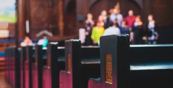 church pews with churchgoers in background