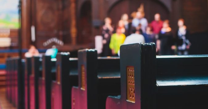 church pews with churchgoers in background