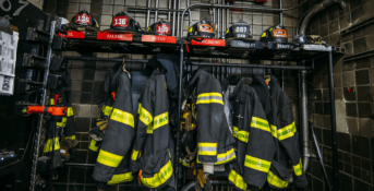 firefighter helmets and jackets hanging up