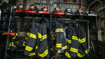 firefighter helmets and jackets hanging up