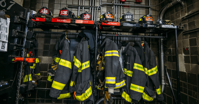 firefighter helmets and jackets hanging up