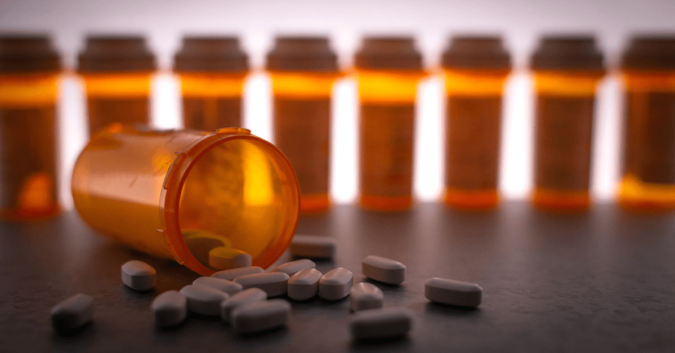 orange prescription bottle and pills