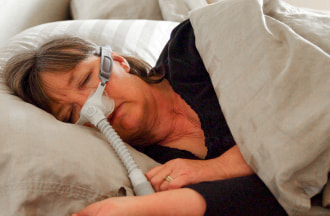 woman sleeping with a cpap machine