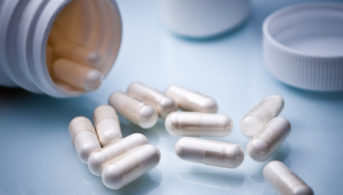 pill bottle and white pills on counter
