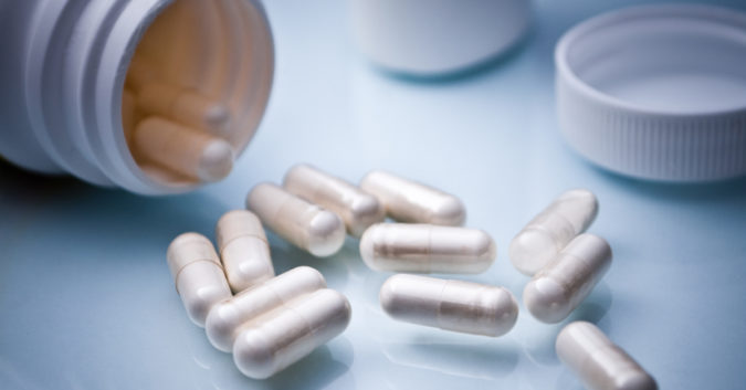 pill bottle and white pills on counter