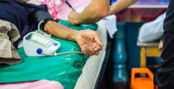 close up of an elderly person's arm in a hospital bed