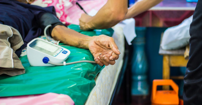 close up of an elderly person's arm in a hospital bed