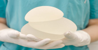 doctor holding breast implants