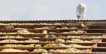worker working on a roof with asbestos