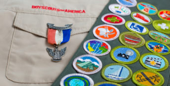 boy scout uniform and sash with badges