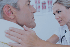 Nursing assisting patient, feeling his neck to check for heart rate.