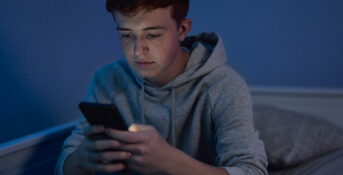 Teen looking at phone screen