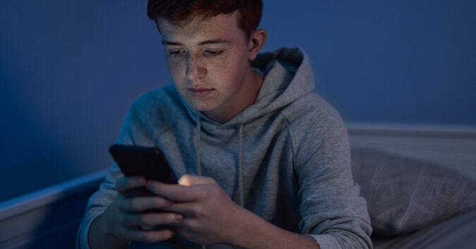 Teen looking at phone screen