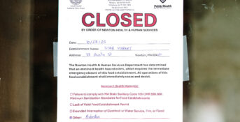 A sign outside of Star Market in Newton, MA states the building is closed due to asbestos